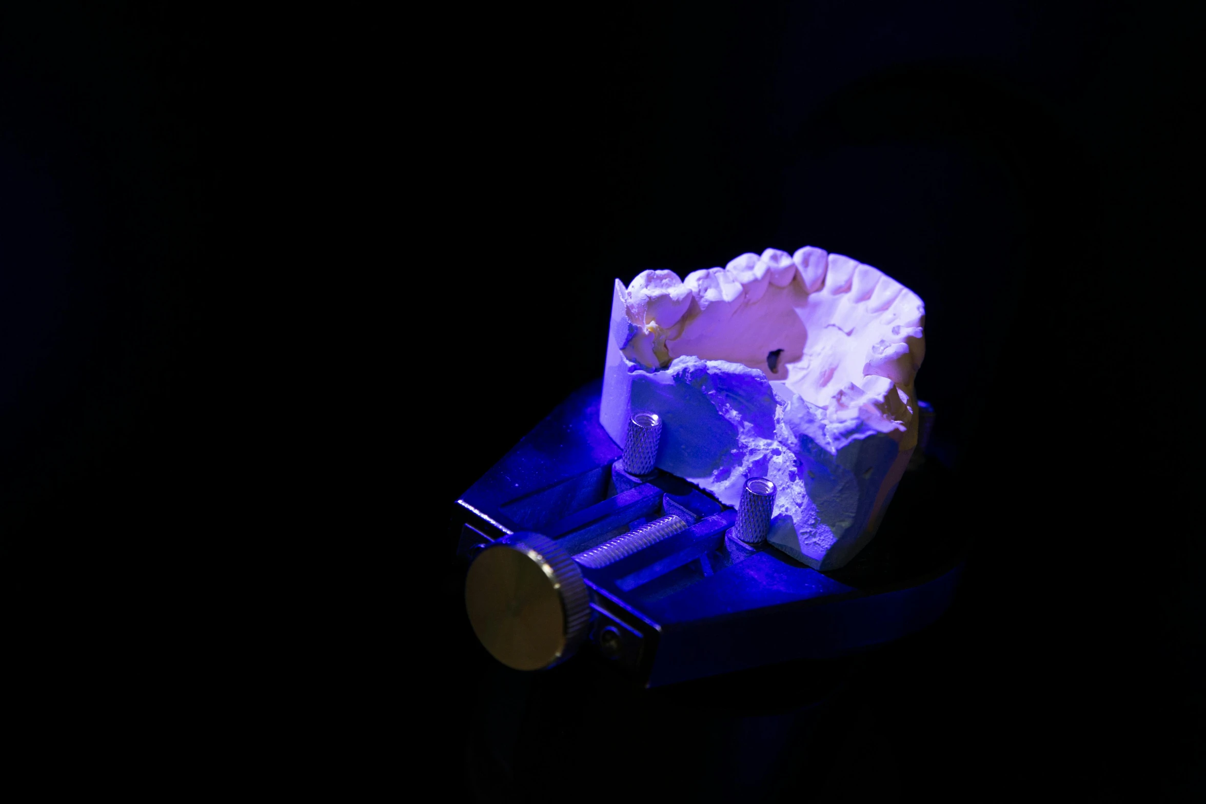 a piece of cake sitting on top of a table, a hologram, by Adam Marczyński, vanitas, high detail teeth, dramatic white and blue lighting, slide show, made of glowing wax and ceramic