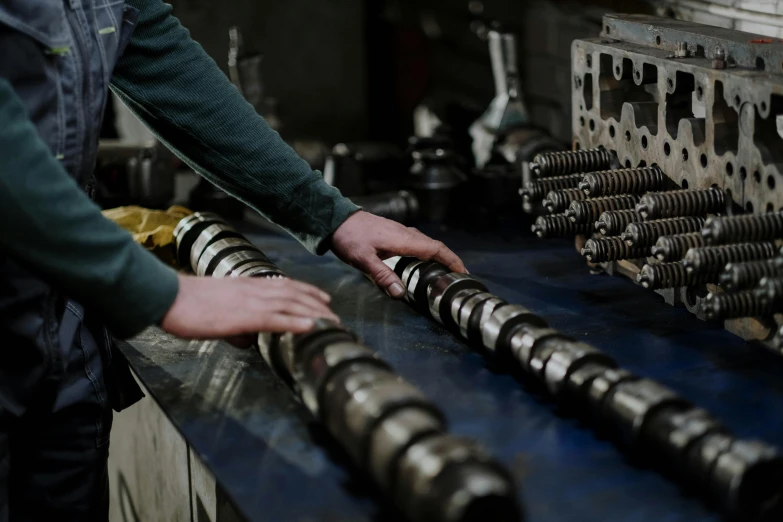 a man working on a machine in a factory, pexels contest winner, deep shafts, large chain, inspect in inventory image, high quality product image”