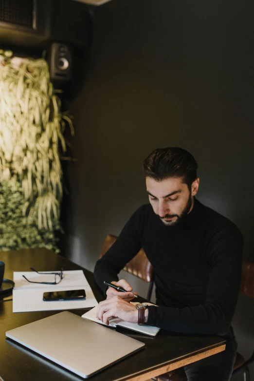 a man sitting at a table working on a laptop, by Sebastian Vrancx, pexels contest winner, black turtleneck, plants, signing a bill, gif