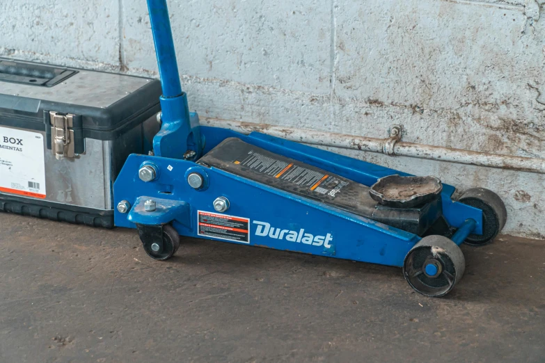 a blue jack sitting on the ground next to a tool box, unsplash, dau-al-set, wheels, official product photo, square, on display