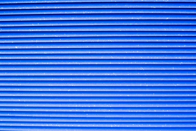 a red fire hydrant sitting in front of a blue wall, a macro photograph, inspired by Andreas Gursky, minimalism, soft light through blinds, 4k (blue)!!, abstract pattern, pvc