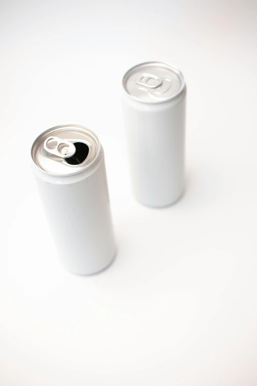 two cans of soda on a white surface, unsplash, multiple stories, ilustration, no - text no - logo, pearlescent white