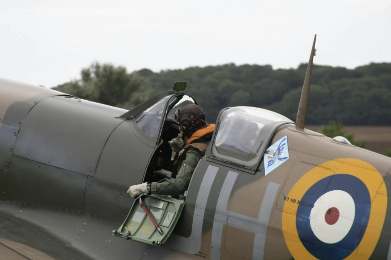 a man sitting in the cockpit of a plane, spitfire, avatar image