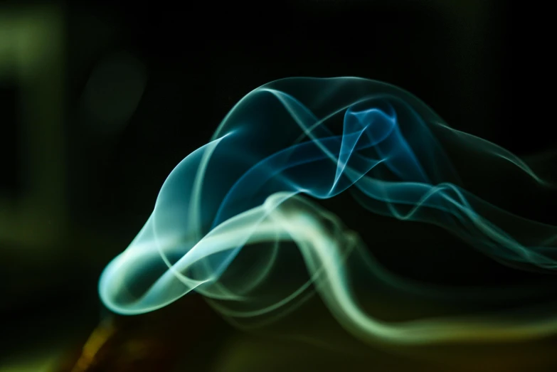 a close up of a cigarette with smoke coming out of it, unsplash, lyrical abstraction, blue and green light, paul barson, flowing tendrils, ghostly form