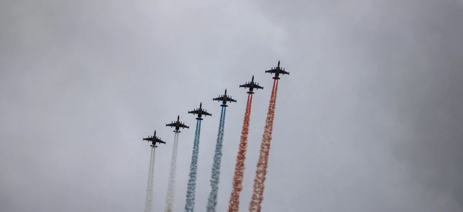 a group of jets flying through a cloudy sky, by Romain brook, pexels contest winner, figuration libre, colors red white blue and black, military parade, hair fanned around, in a row