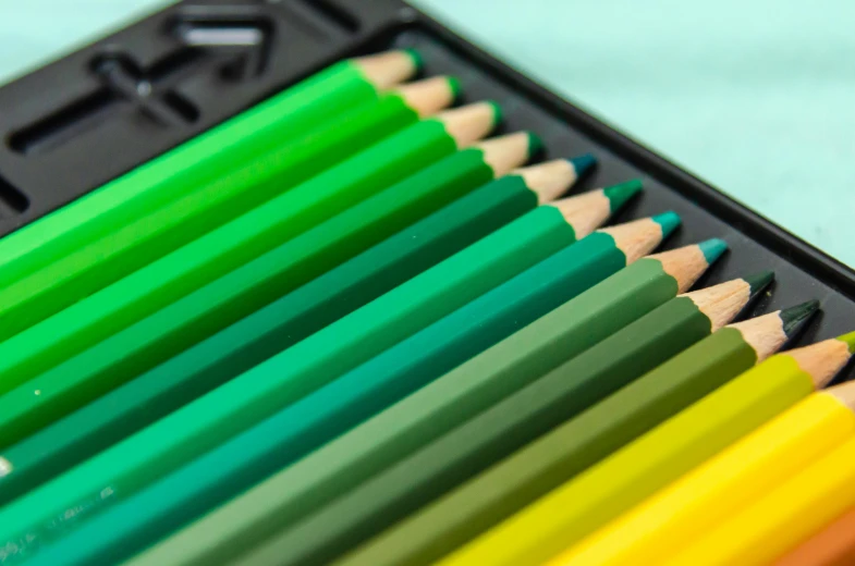 a close up of a bunch of colored pencils, a color pencil sketch, by Carey Morris, pexels contest winner, green and yellow, gradient from green to black, art colouring : roberto bernardi, rectangle