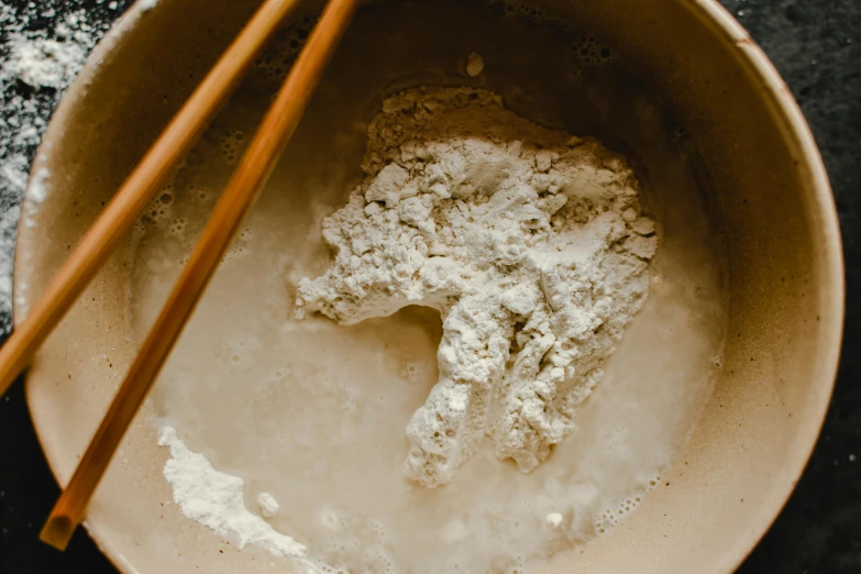 a bowl of flour with chopsticks in it, trending on unsplash, process art, background image, lunar soil, made of glazed, instagram picture