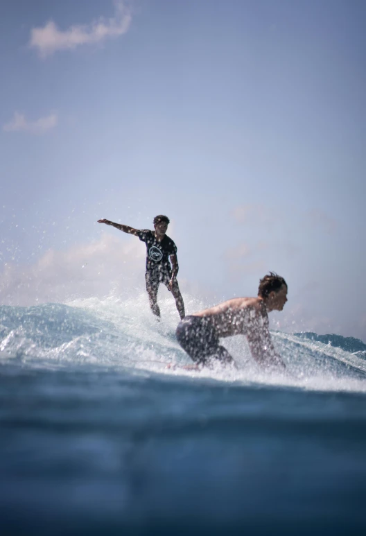 a man riding a wave on top of a surfboard, two male, slide show, sri lanka, o'neill cylinder colony