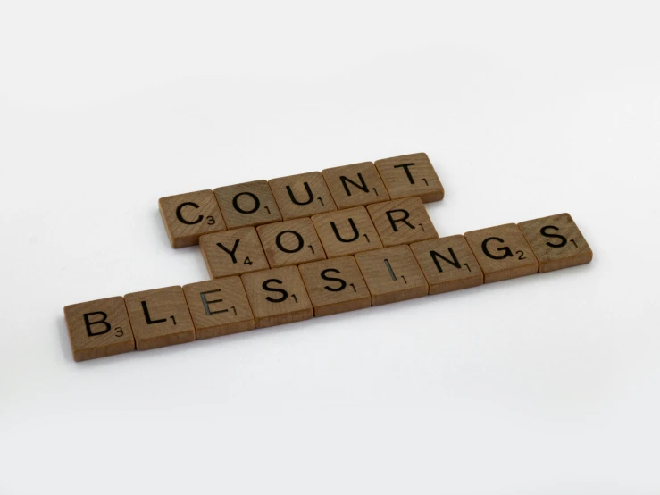 a scrabble that says count your blessings, by Carey Morris, pixabay, square, concrete poetry, 15081959 21121991 01012000 4k, promo image