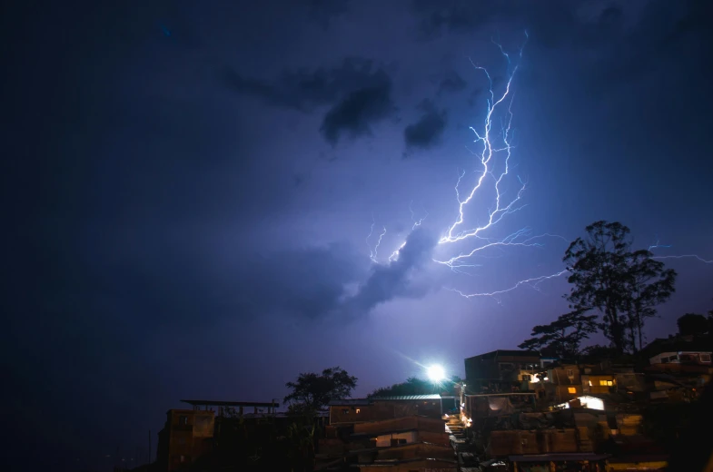 a lightning bolt over a city at night, by Daniel Lieske, pexels contest winner, happening, ☁🌪🌙👩🏾, lightning electricity coil, lightening tree, stacked image