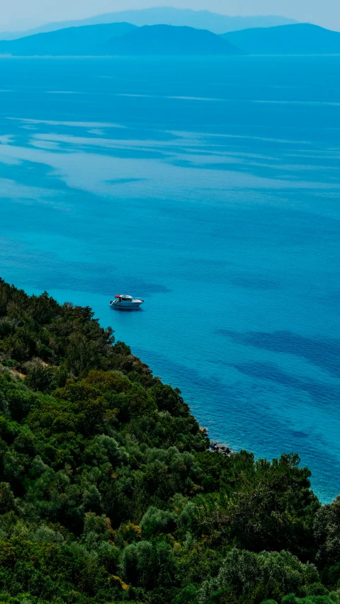 a large body of water sitting on top of a lush green hillside, by Peter Churcher, pexels contest winner, hurufiyya, relaxing on a yacht at sea, square, silver and blue colors, greece