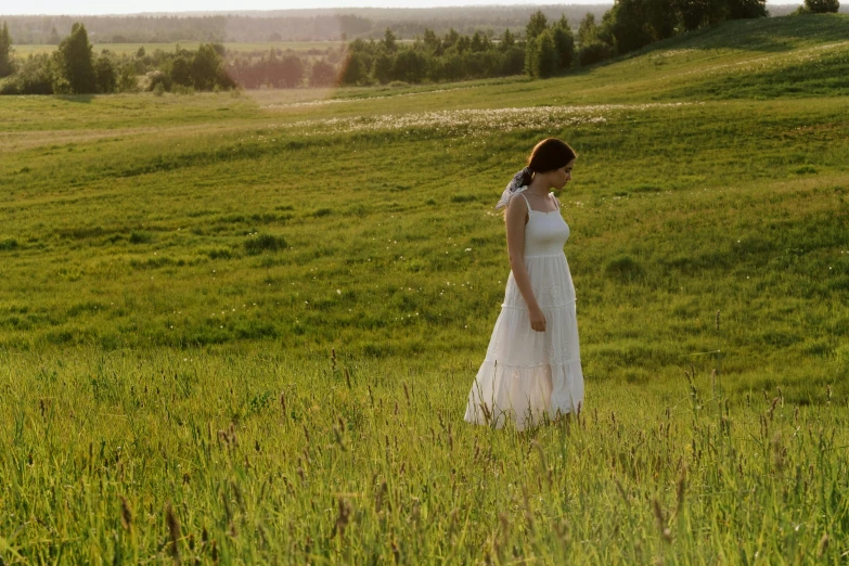 a woman in a white dress standing in a field, a picture, perfectly lit. movie still, midsummer, documentary photo, grassy plains