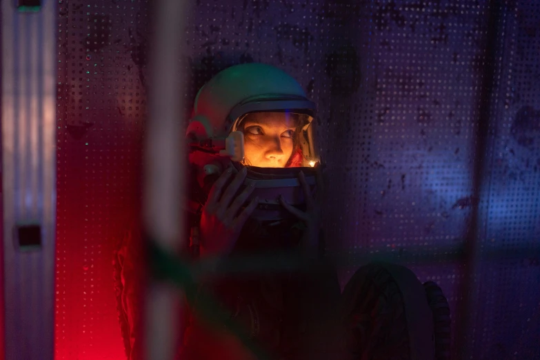 a woman in a helmet talking on a cell phone, pexels contest winner, serial art, luminous cockpit, still image from tv series, scale model photography, jerma in a liminal space