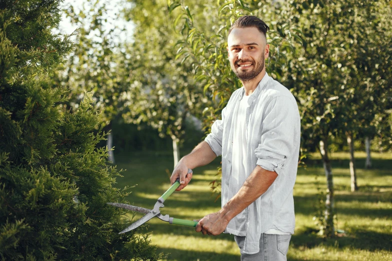 a man cutting a tree with a pair of scissors, a portrait, pexels contest winner, looking smug, garden with fruits on trees, profile image, thumbnail