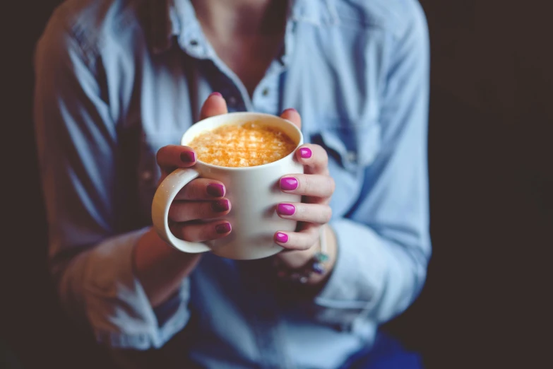 a close up of a person holding a cup of coffee, pink and orange, painted nails, canon 8 5 mm f 1. 2 photograph, gif