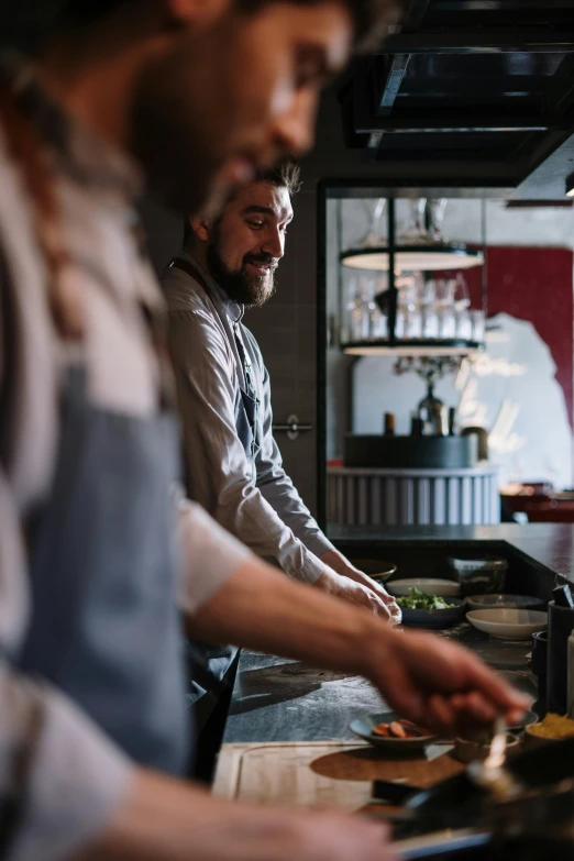 a couple of men standing next to each other in a kitchen, pexels contest winner, renaissance, gourmet restaurant, gif, swedish, middle close up composition