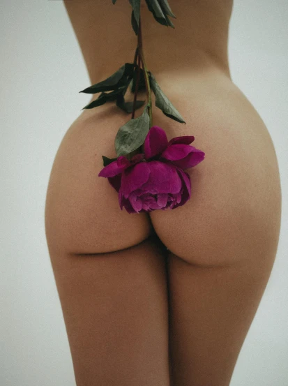 a woman with a flower on her butt, an album cover, unsplash, showstudio, perfect body and face, taken in the late 2010s, violet myers