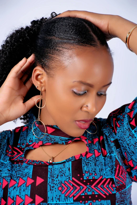 a woman with her hand on her head, inspired by Afewerk Tekle, trending on pexels, flat ironed hair, wearing an african dress, headshot photograph, a high angle shot