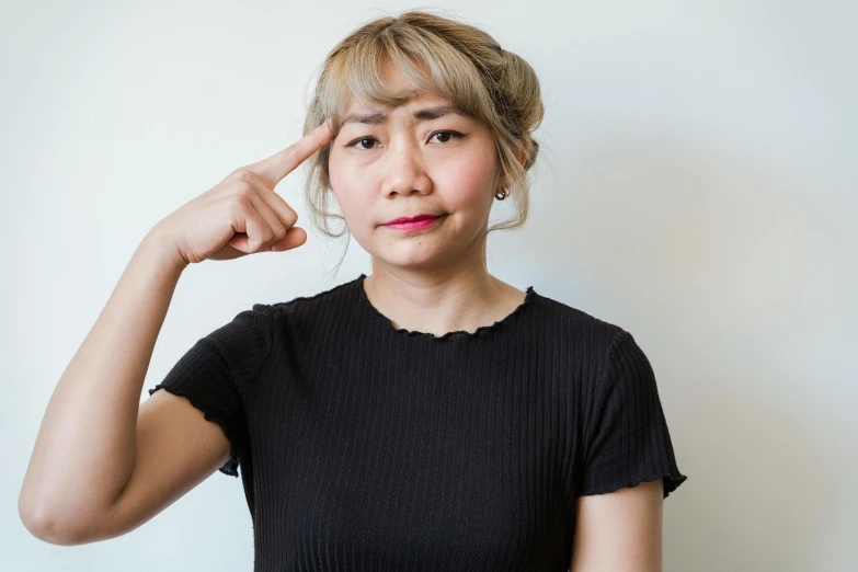 a woman holding a cell phone to her ear, inspired by Yuko Tatsushima, trending on unsplash, realism, giving the middle finger, wrinkly forehead, portrait pose, ethnicity : japanese