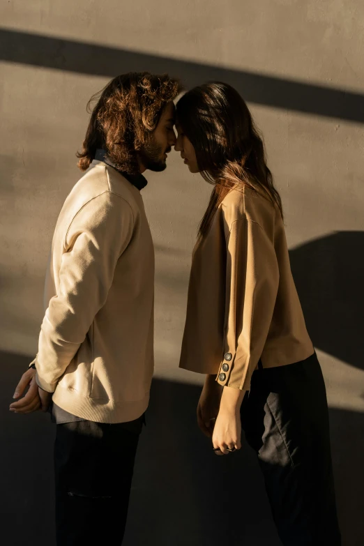 a man and a woman standing next to each other, trending on unsplash, renaissance, wear's beige shirt, open jacket, profile pose, play of light