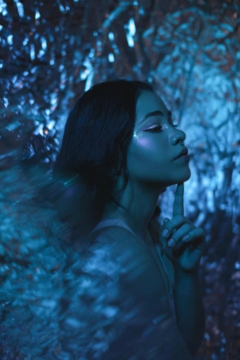 a woman standing in the middle of a forest, an album cover, inspired by Elsa Bleda, trending on pexels, blue neon lighting, profile pose, portrait of vanessa morgan, girl with blue hair