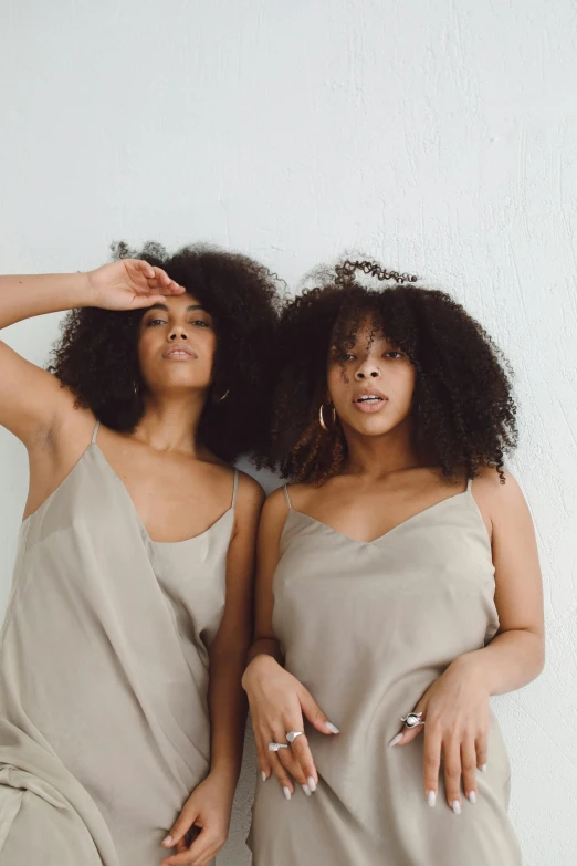 a couple of women standing next to each other, by Lily Delissa Joseph, trending on unsplash, renaissance, wavy hair spread out, modern earthy neutral earthy, wearing a camisole, photoshoot for skincare brand