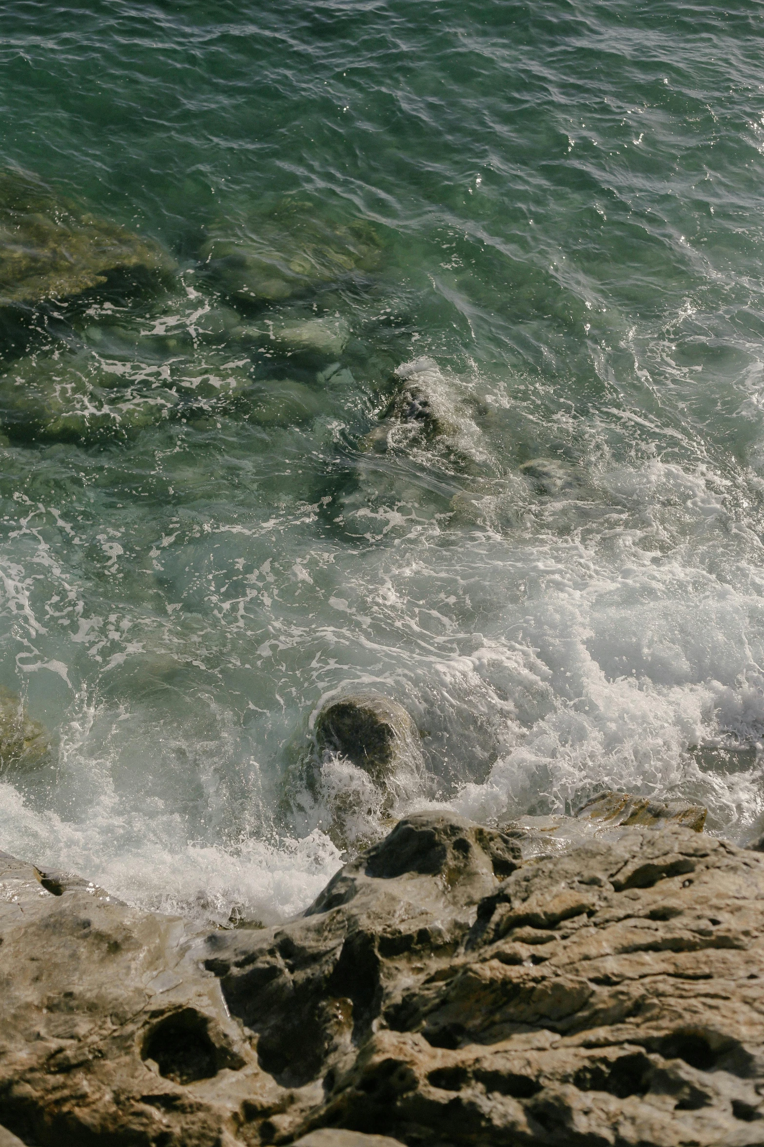 a man riding a wave on top of a surfboard, an album cover, inspired by Thomas Struth, unsplash, romanticism, floating rocks, croatian coastline, photo taken on fujifilm superia, close - up photograph