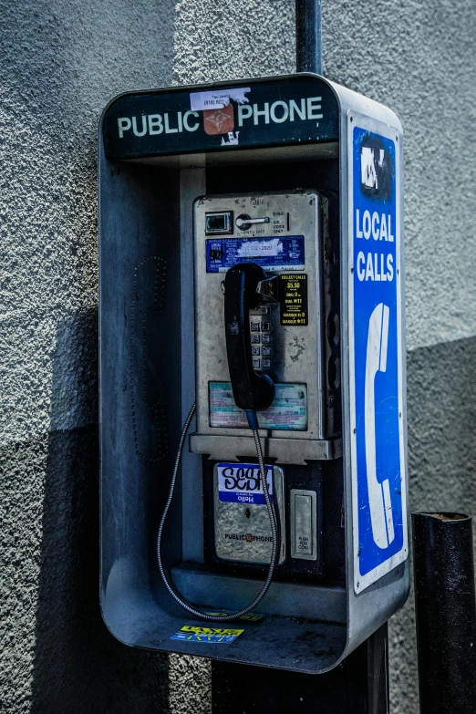 a public phone sitting on the side of a building, paul barson, 2022 photograph, small