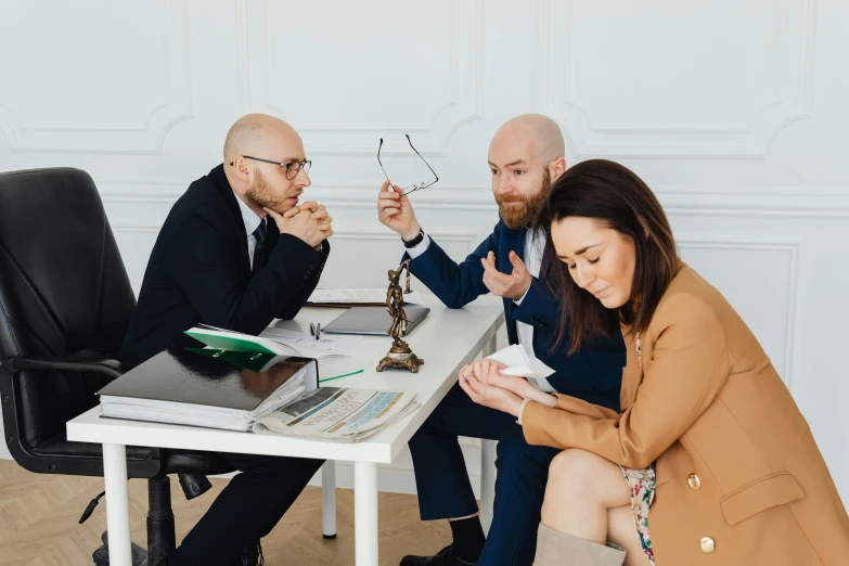 a couple of people that are sitting at a table, lawyer, on a white table, 3 heads, 2019 trending photo
