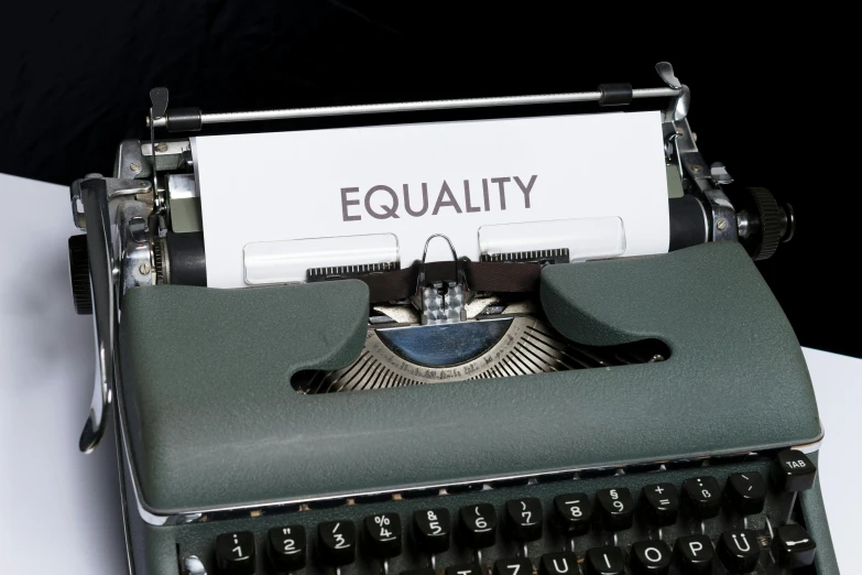 a typewriter sitting on top of a white table, excessivism, balancing the equation, pride month, getty images, ( ( dark skin ) )