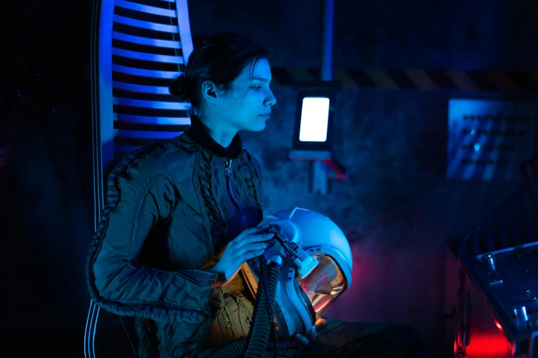 a person sitting in a chair with a helmet on, the expanse, glow, set photograph, charli bowater and artgeem