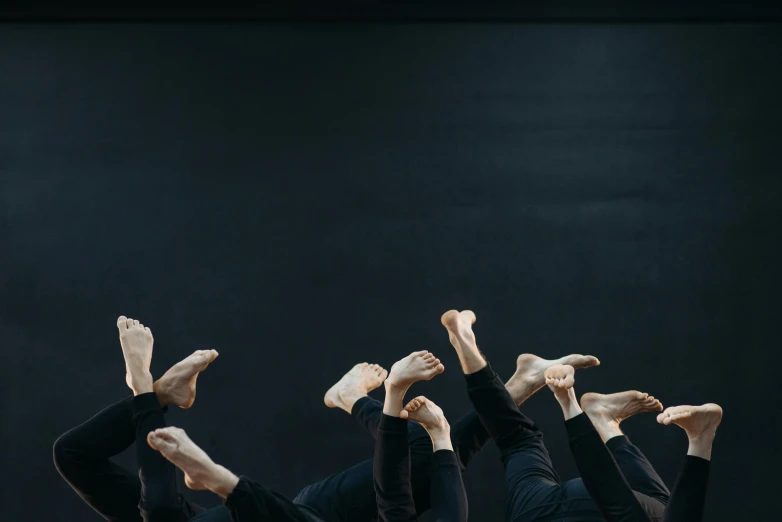 a group of dancers in black leo leo leo leo leo leo leo leo leo leo leo leo, an album cover, by Nina Hamnett, unsplash, arabesque, feet, backdrop, 15081959 21121991 01012000 4k, folded