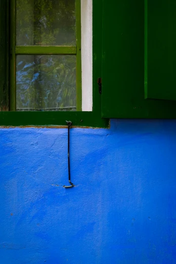 a blue floor with a green window and green shutters, a painting, unsplash, color field, juan miro, electric blue, greece, in profile