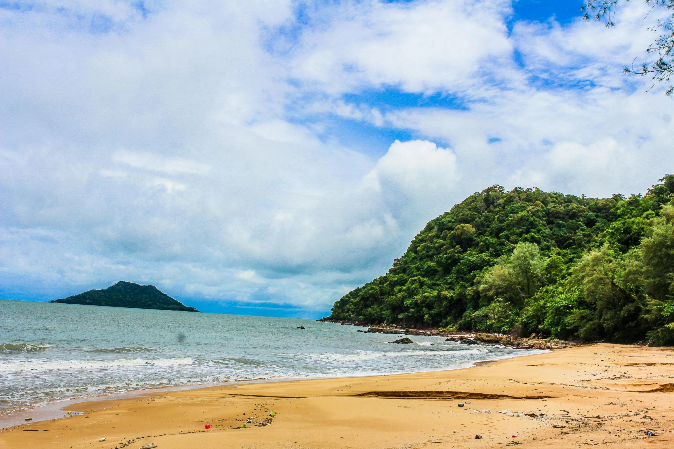 a boat sitting on top of a sandy beach next to the ocean, malaysia jungle, profile image, fan favorite, hills and ocean