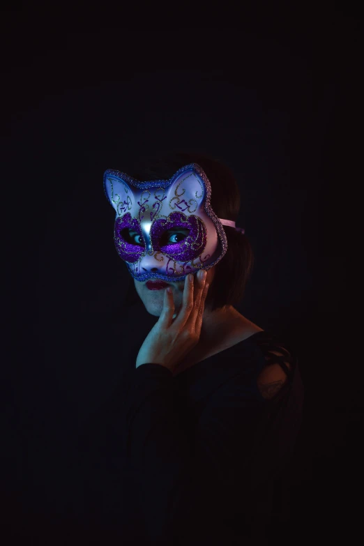 a person wearing a cat mask in the dark, an album cover, pexels, purple and blue colored, intricate led jewellery, adafruit, #trending