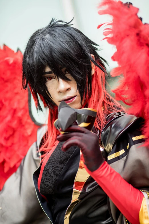 a close up of a person holding a cell phone, inspired by Okumura Masanobu, black and red silk clothing, male jester, with his long black hair, cosplayer