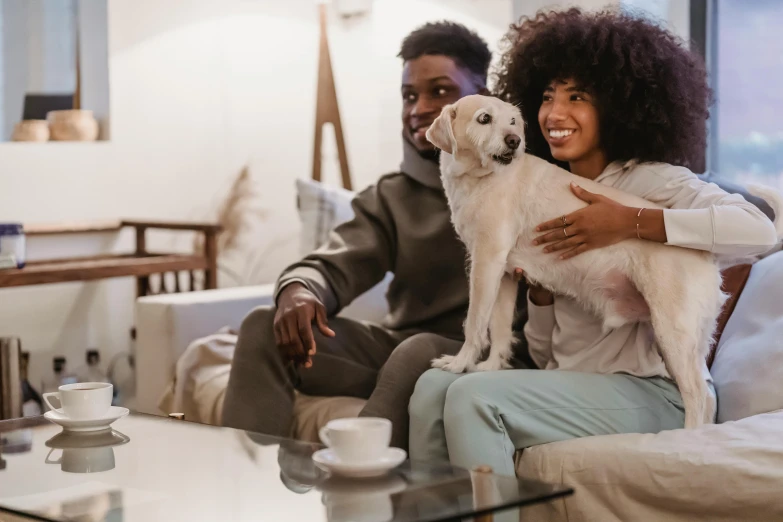 a man and woman sitting on a couch with a dog, pexels contest winner, renaissance, diverse, joyful people in the house, maintenance, cutest