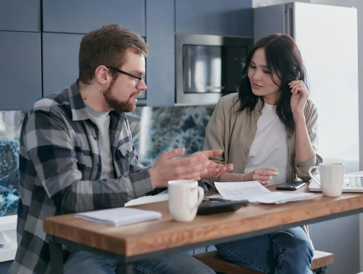 a man and a woman sitting at a kitchen table, selling insurance, wētā fx, australian, brown