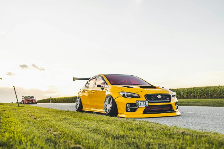 a yellow car parked on the side of a road, a picture, by David Small, unsplash, wrx golf, avatar image, wide body, samurai vinyl wrap