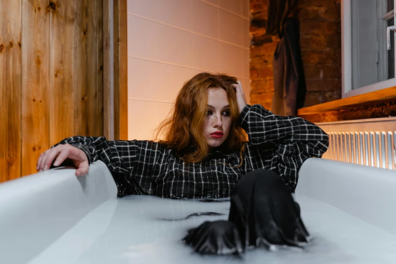 a woman sitting in a bathtub with her hands on her head, inspired by Elsa Bleda, trending on pexels, gothic outfit, ginger hair, rectangle, abcdefghijklmnopqrstuvwxyz