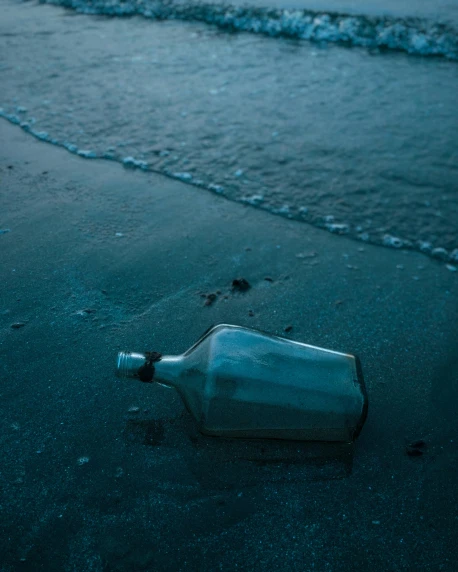 a bottle sitting on top of a beach next to the ocean, profile image, found objects, dark blue water, multiple stories