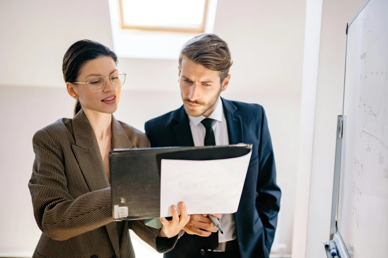 a man and a woman looking at a piece of paper, hip corporate, profile image, thumbnail, high quality image