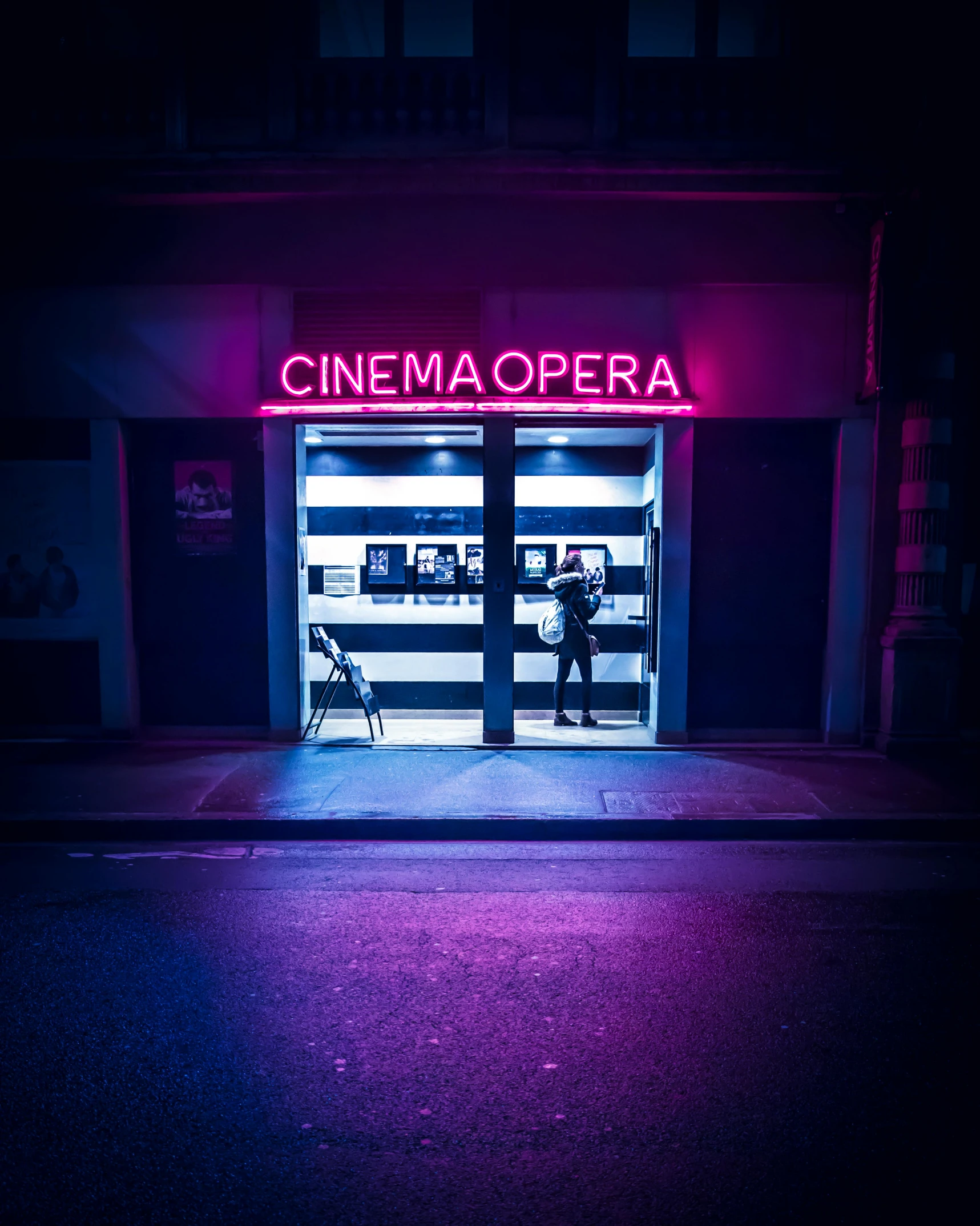 a building with a neon sign that says cinema opera, inspired by Elsa Bleda, unsplash contest winner, alessio albi, storefront, purple scene lighting, cinematic outfit photo