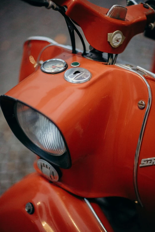 a close up of a motor scooter's headlight, a picture, by Sven Erixson, pexels contest winner, orange body, square, slightly red, 1 9 6 0