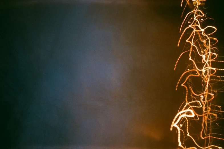 a lighted christmas tree in a dark room, an album cover, by Attila Meszlenyi, unsplash, light and space, firework, expired burned film from 1930s, fourth of july, photo taken on fujifilm superia