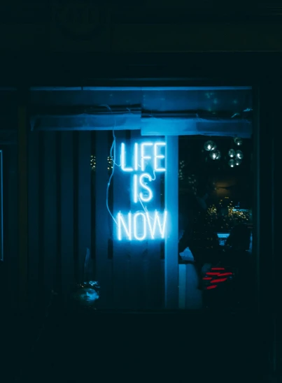 a neon sign that says life is now, unsplash contest winner, happening, blue mood, profile image, grown up, high quality photo