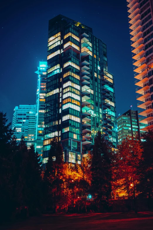 a couple of tall buildings sitting next to each other, by Sebastian Vrancx, unsplash contest winner, vancouver school, night forest, late summer evening, 8k resolution”, low detail