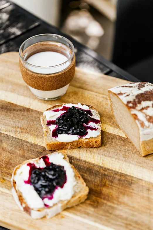 a wooden cutting board topped with slices of bread, by Daniel Seghers, unsplash, maple syrup & hot fudge, cream, squashed berry stains, eastern european origin
