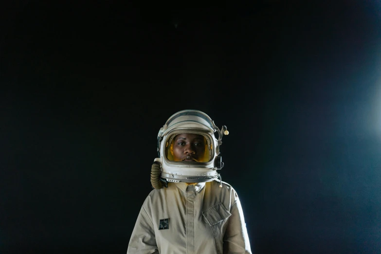 a close up of a person in a space suit, a portrait, by Alison Geissler, pexels contest winner, afrofuturism, full body photograph, concern, taken in the late 2010s, portrait of small