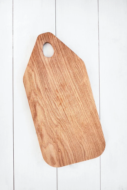 a wooden cutting board on a white table, sienna, angled shot, feature, hanging